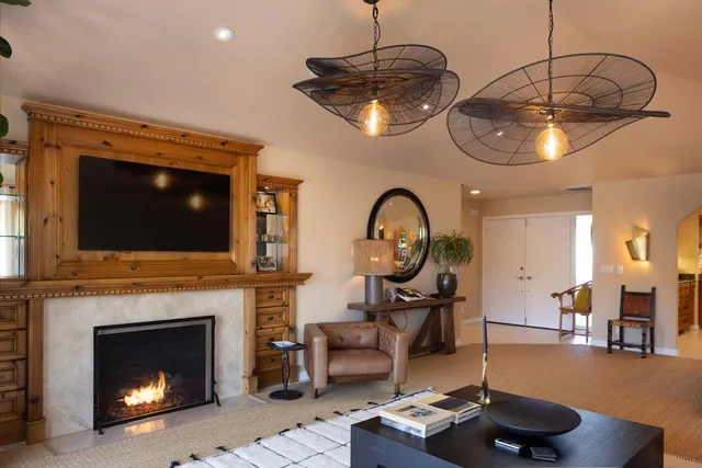 a living room with furniture a flat screen tv and a fireplace