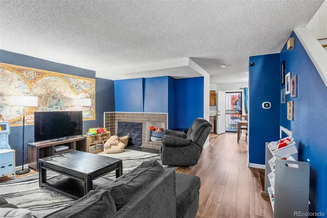 a living room with furniture a flat screen tv and a window