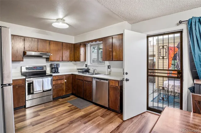 a kitchen with a refrigerator sink and cabinets