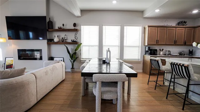 a living room with furniture a flat screen tv and a floor to ceiling window