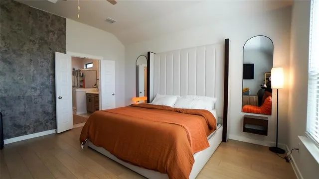 a bedroom with a bed and a mirror