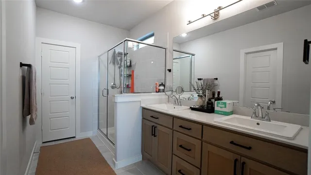 a bathroom with a double vanity sink mirror and double