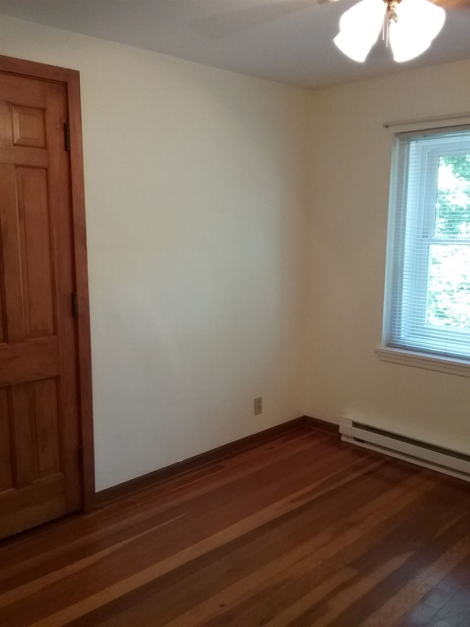 708 Pines Road Oregon, IL 61061 - Photo 11 of 22 an empty room with wooden floor and windows