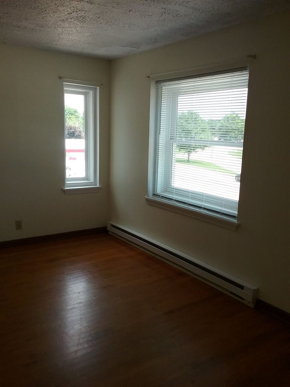 708 Pines Road Oregon, IL 61061 - Photo 13 of 22 a view of an empty room with wooden floor and a window