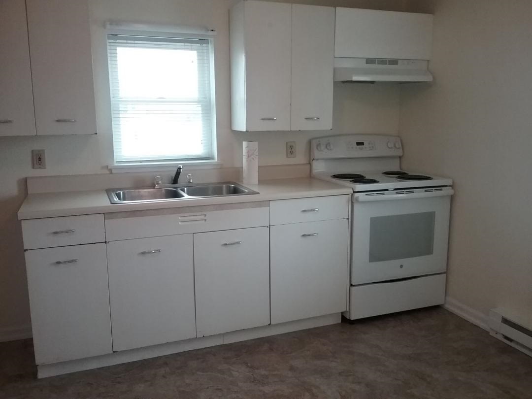 708 Pines Road Oregon, IL 61061 - Photo 18 of 22 a kitchen with white cabinets appliances and sink