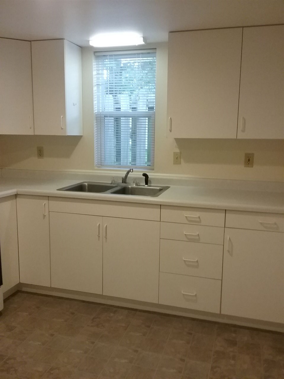 708 Pines Road Oregon, IL 61061 - Photo 2 of 22 a kitchen with white cabinets and a sink