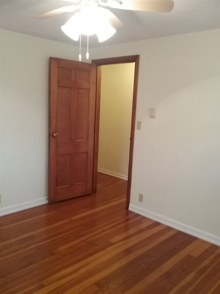 708 Pines Road Oregon, IL 61061 - Photo 6 of 22 a view of empty room with wooden floor and fan