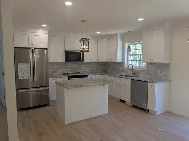 a kitchen with a refrigerator and a sink