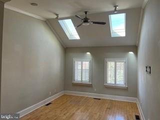 3409 Dillon Street Baltimore, MD 21224 - Photo 12 of 18 an empty room with wooden floor and windows