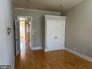 3409 Dillon Street Baltimore, MD 21224 - Photo 13 of 18 a view of a hallway with wooden floor