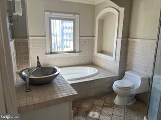 3409 Dillon Street Baltimore, MD 21224 - Photo 15 of 18 a bathroom with a toilet and a sink