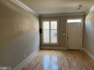 3409 Dillon Street Baltimore, MD 21224 - Photo 2 of 18 an empty room with wooden floor and windows