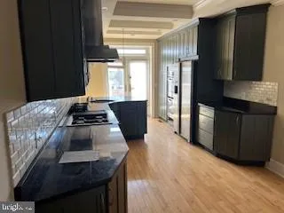 a kitchen with granite countertop stainless steel appliances a counter space and a window