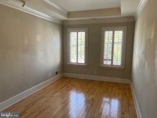 3409 Dillon Street Baltimore, MD 21224 - Photo 7 of 18 an empty room with wooden floor and windows