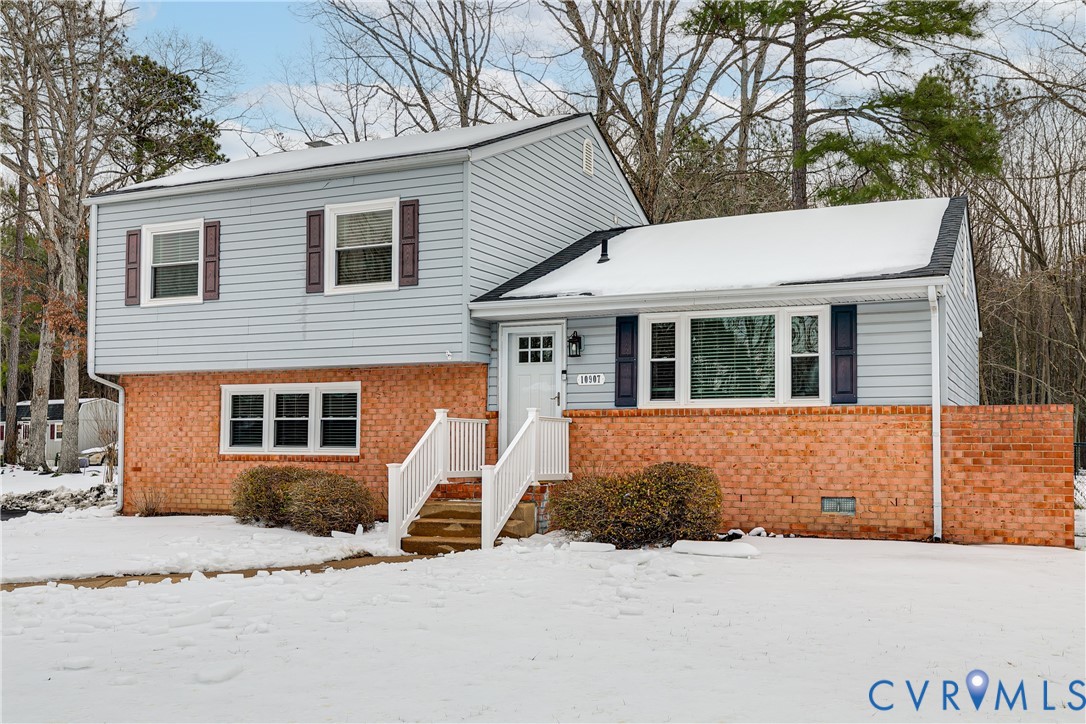 10907 Baxter Road Glen Allen, VA 23060 - Photo 2 of 42 a front view of a house with a yard and garage