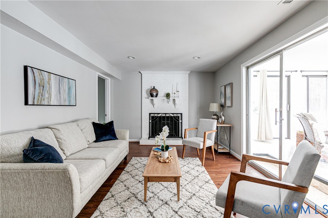 10907 Baxter Road Glen Allen, VA 23060 - Photo 29 of 42 a living room with furniture a fireplace and a large window