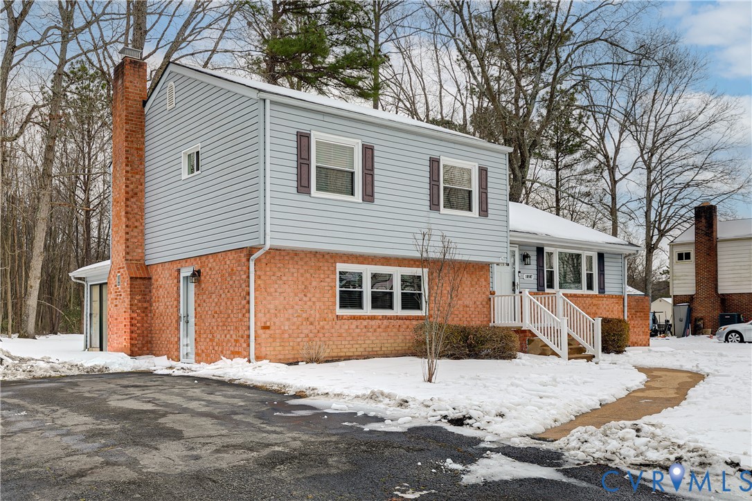10907 Baxter Road Glen Allen, VA 23060 - Photo 3 of 42 a front view of a house with a yard covered in snow