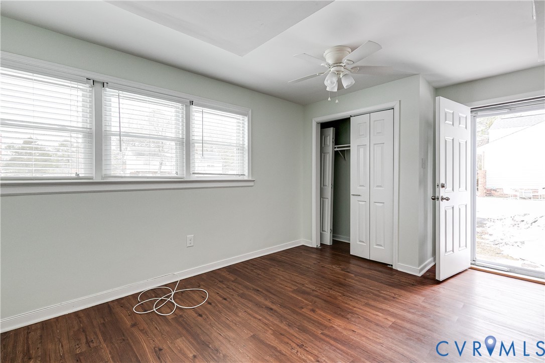 10907 Baxter Road Glen Allen, VA 23060 - Photo 34 of 42 an empty room with wooden floor chandelier and windows