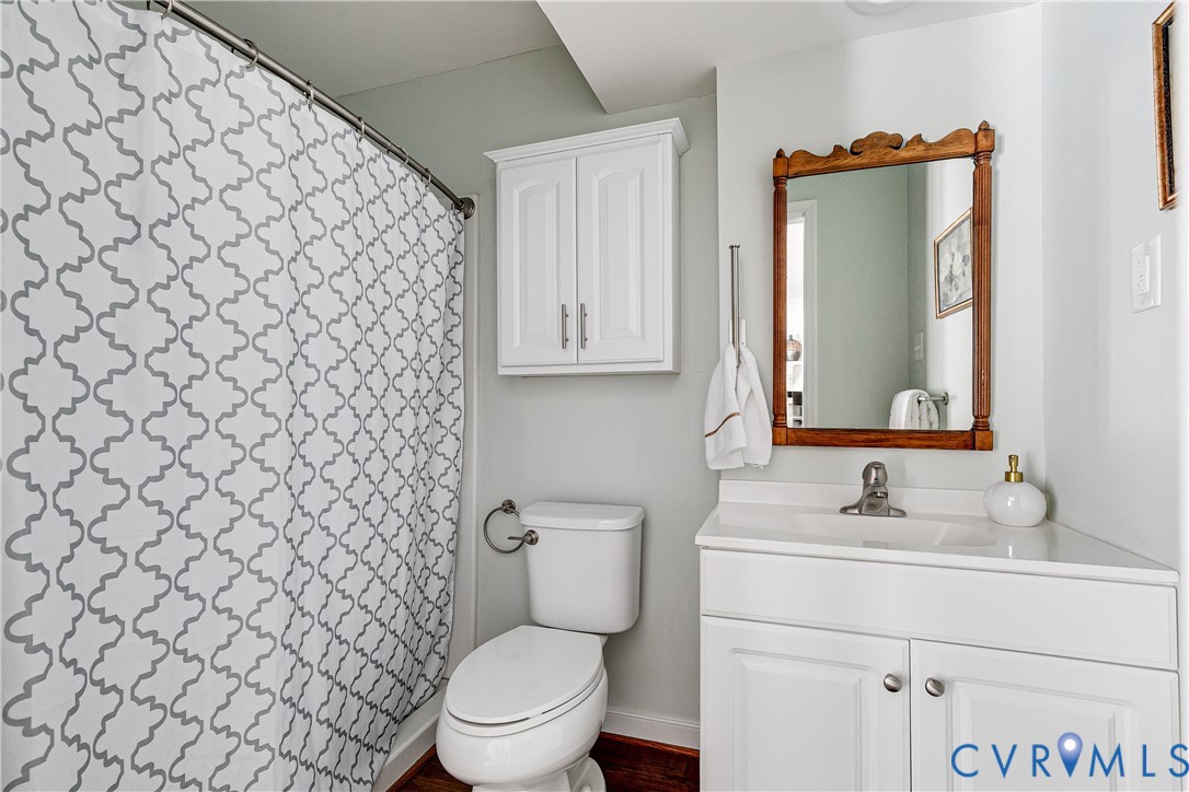 10907 Baxter Road Glen Allen, VA 23060 - Photo 35 of 42 a bathroom with a granite countertop toilet sink and mirror