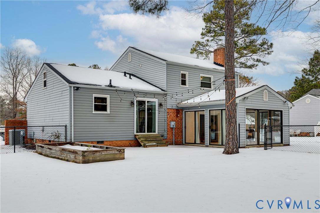 10907 Baxter Road Glen Allen, VA 23060 - Photo 40 of 42 a view of a white house with large windows and a table and chairs