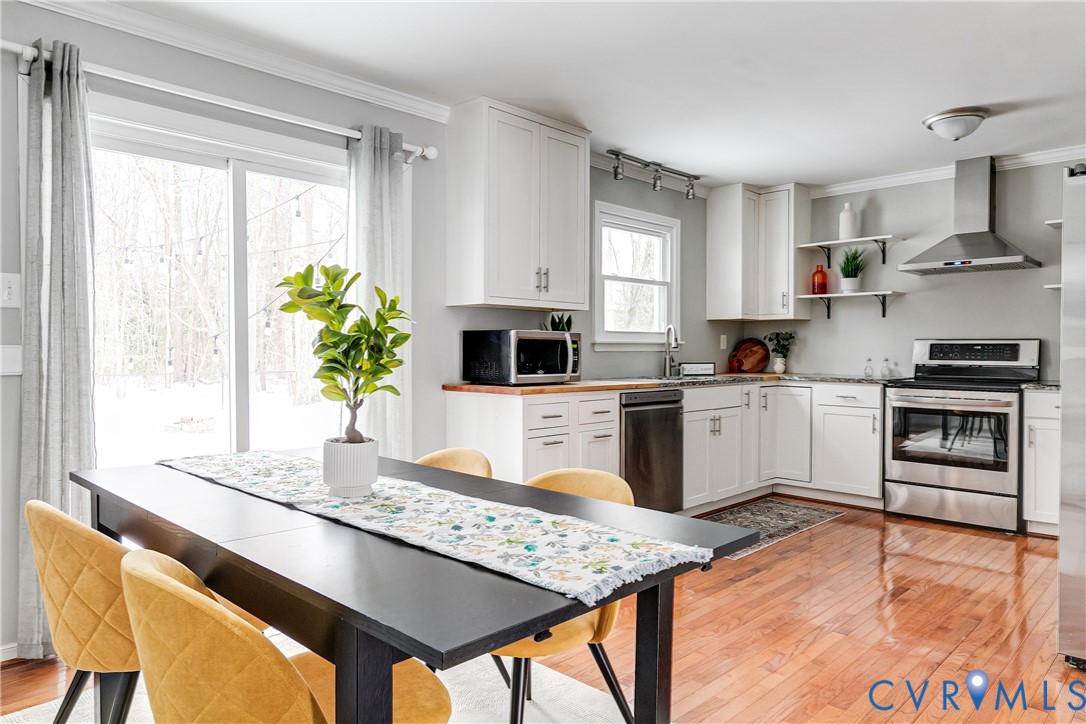 10907 Baxter Road Glen Allen, VA 23060 - Photo 9 of 42 a kitchen with stainless steel appliances kitchen island granite countertop a stove a sink and a microwave