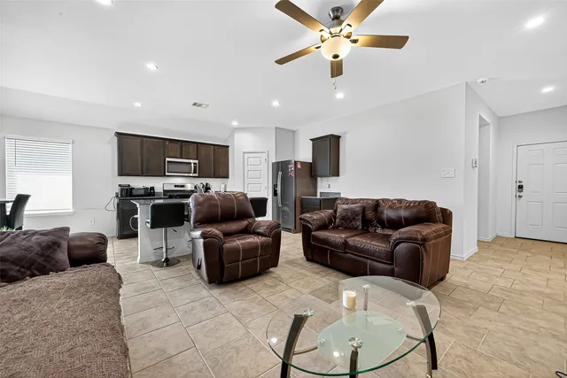 a kitchen with stainless steel appliances granite countertop a stove microwave and refrigerator