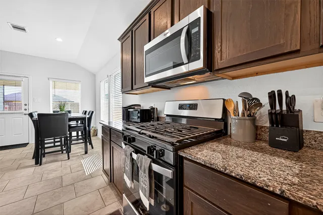 a view of a dining room with furniture and window