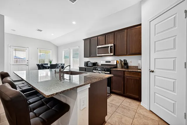 a view of a dining room with furniture and a window