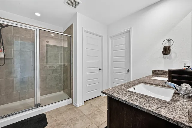 a bathroom with a granite countertop sink a toilet and mirror