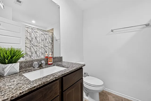 a bedroom with furniture and a flat screen tv