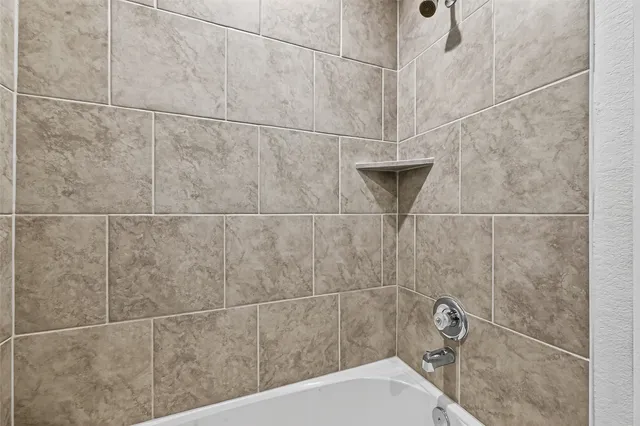 a view of a backyard with grass and wooden fence