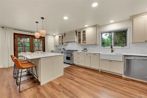 a kitchen with a sink window and cabinets