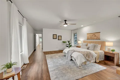 a spacious bedroom with a large bed and a chandelier