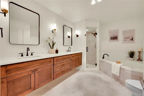 a spacious bathroom with a double vanity sink double mirror and bathtub