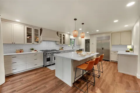 a kitchen with stainless steel appliances kitchen island granite countertop a sink and cabinets