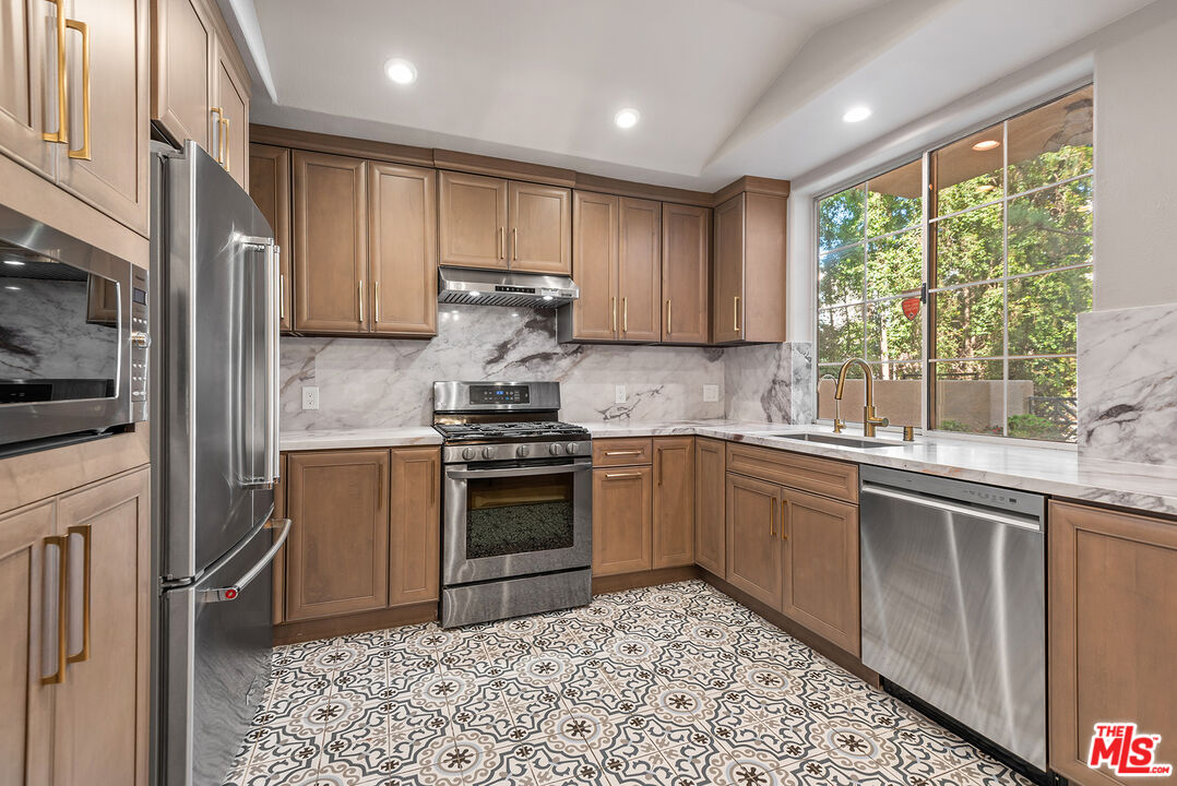 1875 South Beverly Glen Boulevard, Unit 106 Los Angeles, CA 90025 - Photo 11 of 30 a kitchen with a sink stove and refrigerator