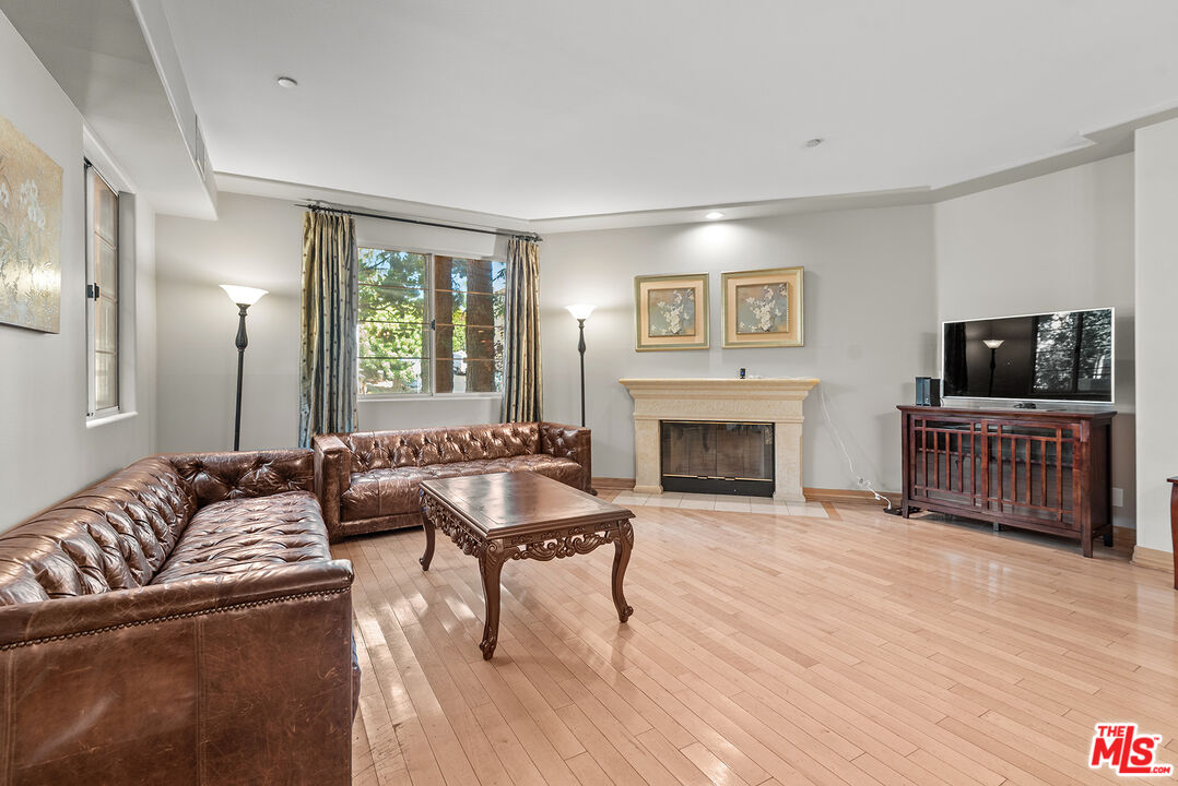1875 South Beverly Glen Boulevard, Unit 106 Los Angeles, CA 90025 - Photo 13 of 30 a living room with furniture and a fireplace