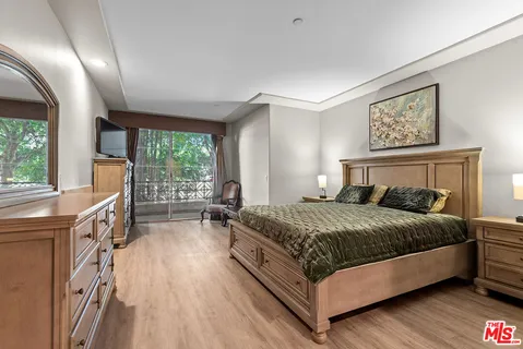 a bedroom with a large bed and a large window