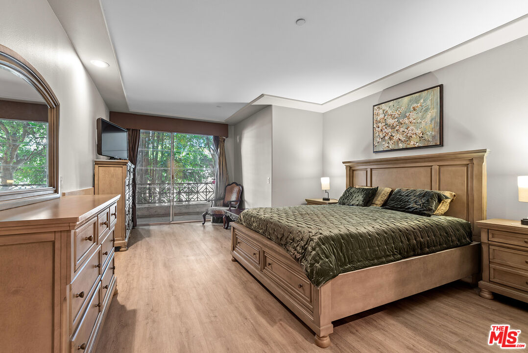1875 South Beverly Glen Boulevard, Unit 106 Los Angeles, CA 90025 - Photo 14 of 30 a bedroom with a large bed and a large window
