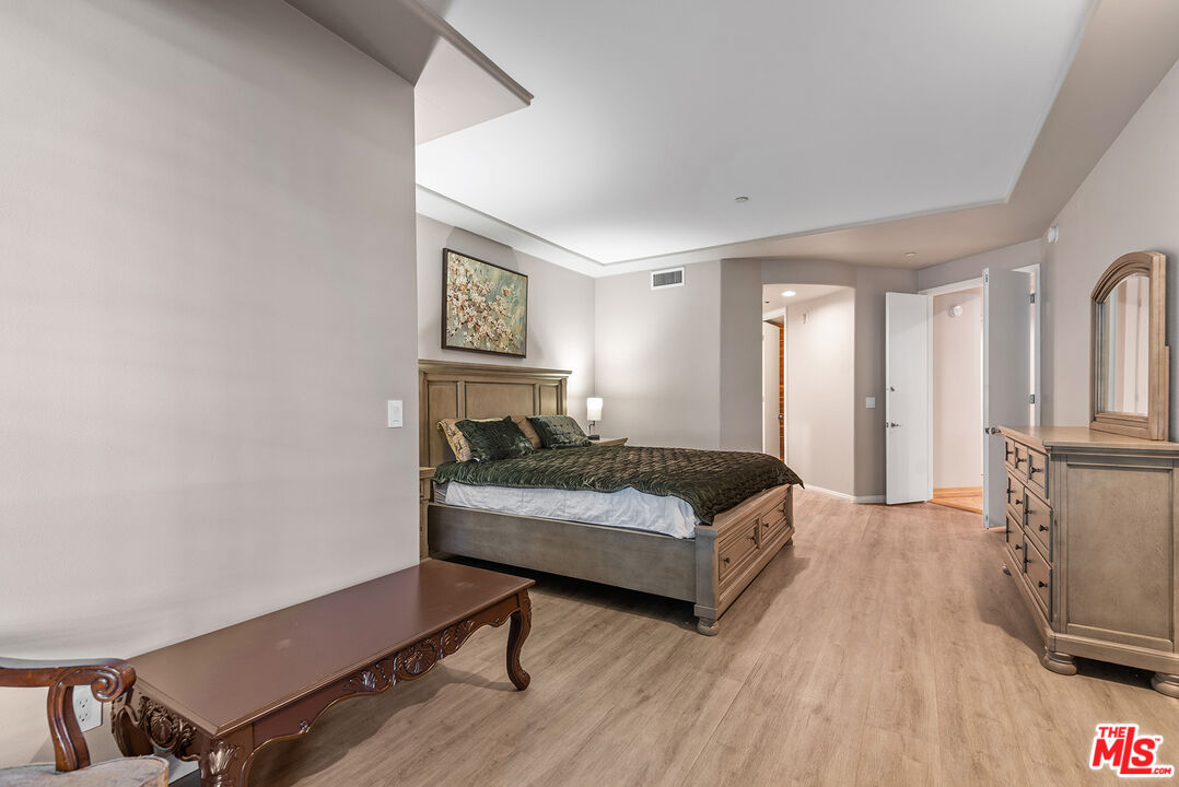 1875 South Beverly Glen Boulevard, Unit 106 Los Angeles, CA 90025 - Photo 16 of 30 a bedroom with a bed and a tv on table