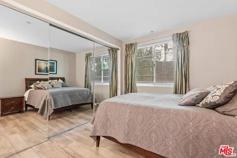 a bedroom with a large bed and a large window