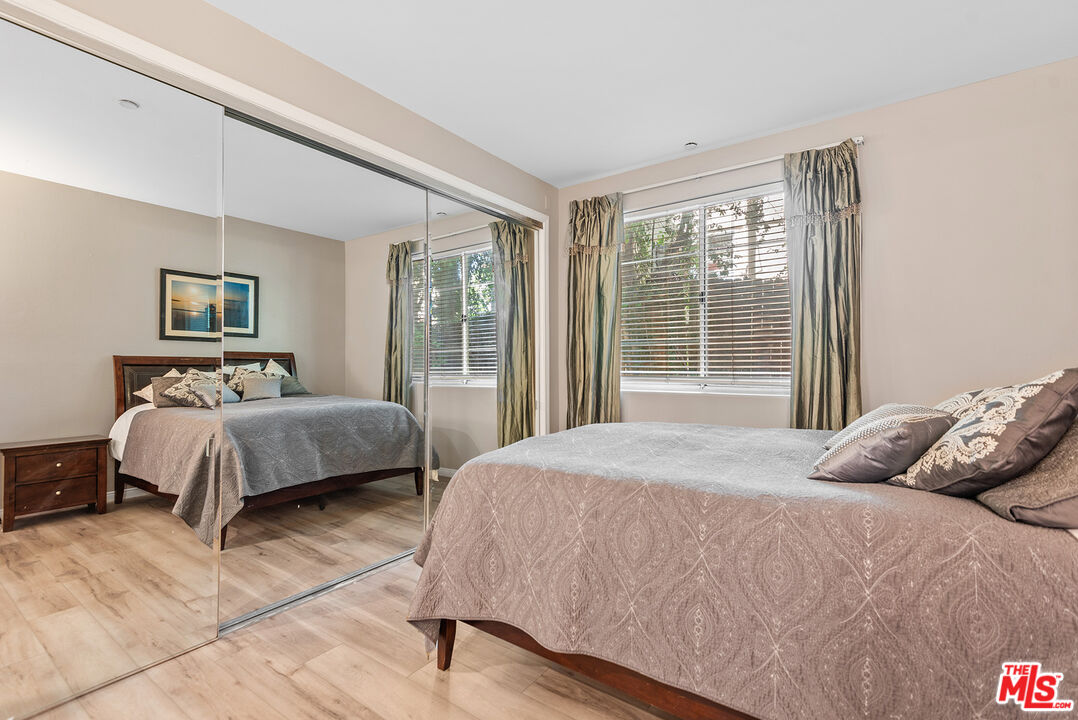 1875 South Beverly Glen Boulevard, Unit 106 Los Angeles, CA 90025 - Photo 22 of 30 a bedroom with a large bed and a large window