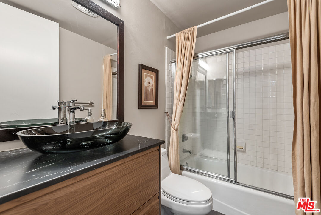 1875 South Beverly Glen Boulevard, Unit 106 Los Angeles, CA 90025 - Photo 23 of 30 a bathroom with a granite countertop sink toilet and shower