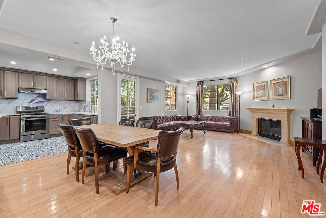 1875 South Beverly Glen Boulevard, Unit 106 Los Angeles, CA 90025 - Photo 6 of 30 a view of a dining room with furniture a fireplace and wooden floor