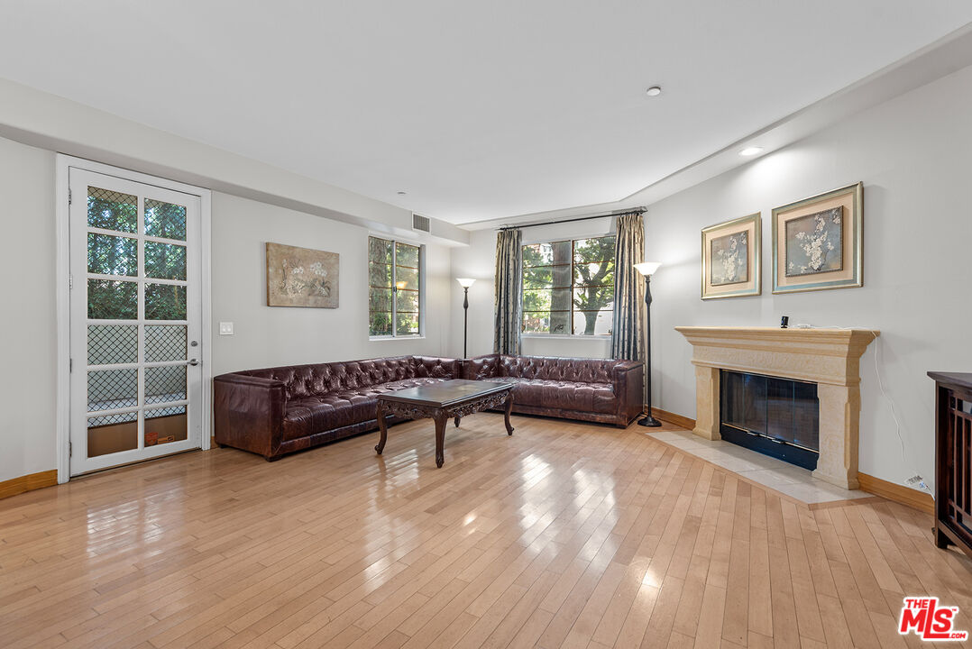1875 South Beverly Glen Boulevard, Unit 106 Los Angeles, CA 90025 - Photo 7 of 30 a living room with furniture and a fireplace