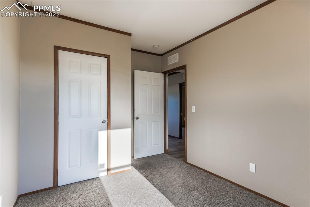 703 Buffalo Run Road Calhan, CO 80808 - Photo 18 of 25 a view of a hallway with closet