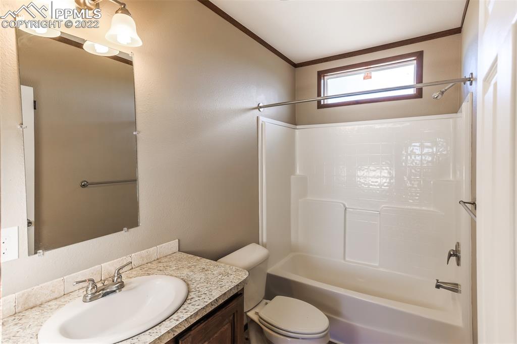 703 Buffalo Run Road Calhan, CO 80808 - Photo 19 of 25 a bathroom with a granite countertop toilet sink and shower