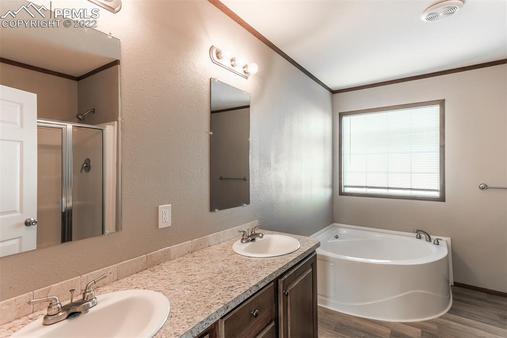 703 Buffalo Run Road Calhan, CO 80808 - Photo 21 of 25 a bathroom with a granite countertop sink and a mirror