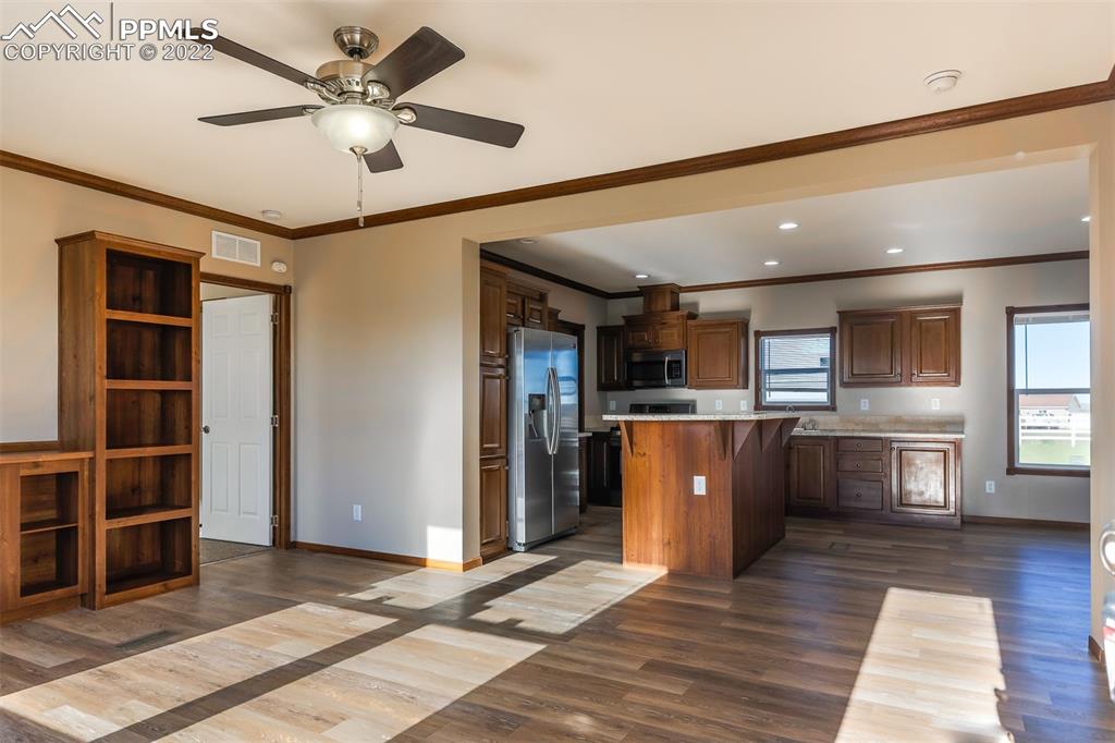 703 Buffalo Run Road Calhan, CO 80808 - Photo 6 of 25 a living room with stainless steel appliances kitchen island granite countertop furniture and a kitchen view