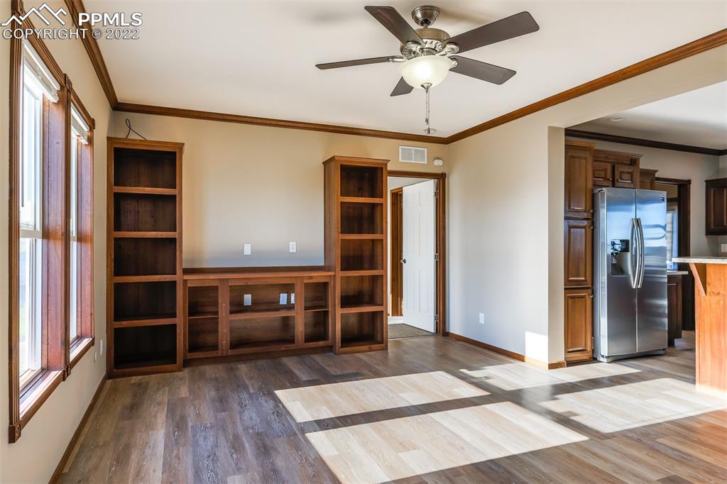 703 Buffalo Run Road Calhan, CO 80808 - Photo 7 of 25 a view of empty room with wooden floor and fan